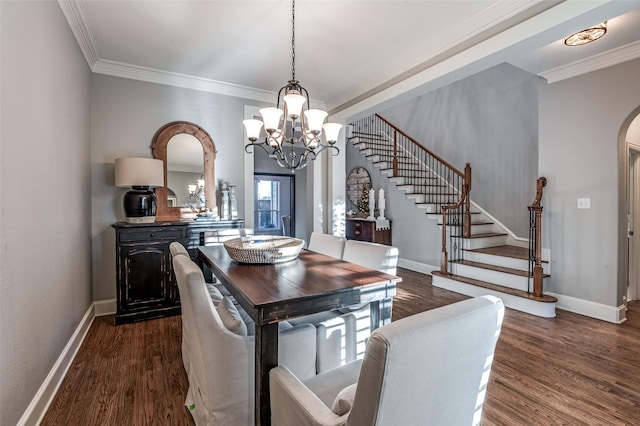 dining space with ornamental molding, dark wood-type flooring, and a notable chandelier