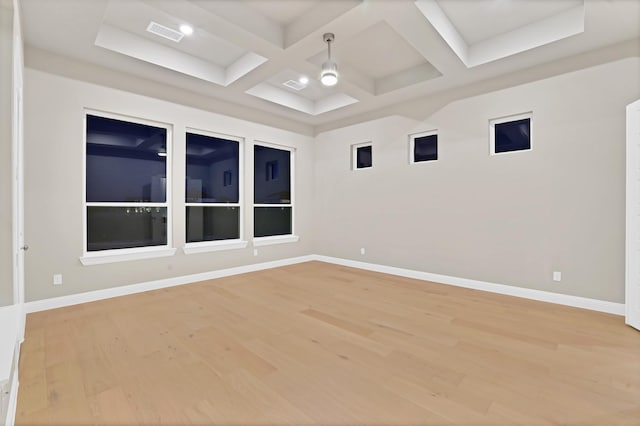 spare room featuring beamed ceiling, hardwood / wood-style flooring, and coffered ceiling