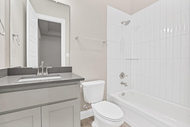 full bathroom featuring vanity, tiled shower / bath combo, and toilet