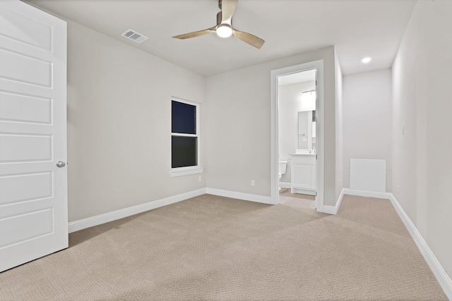 empty room with ceiling fan and light colored carpet