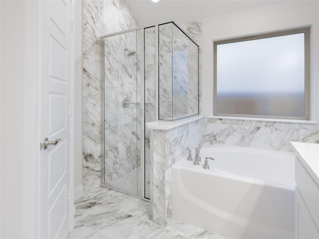 bathroom with vanity and shower with separate bathtub