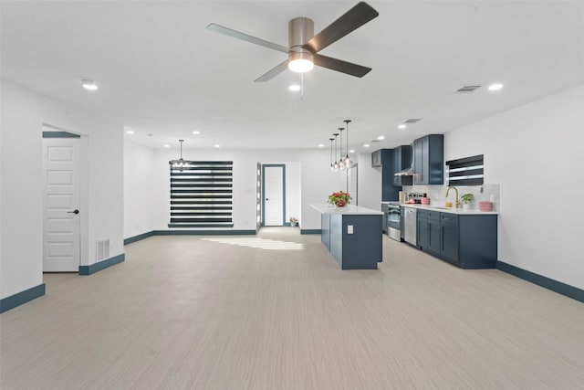 kitchen with stainless steel electric range oven, a kitchen island, tasteful backsplash, hanging light fixtures, and ceiling fan