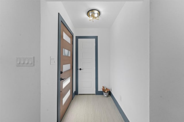 doorway to outside with baseboards