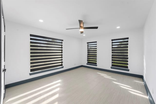 empty room with ceiling fan, recessed lighting, and baseboards