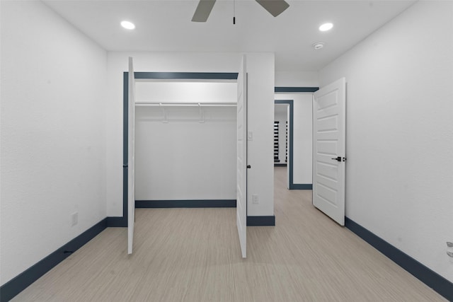 unfurnished bedroom featuring baseboards, ceiling fan, wood finished floors, a closet, and recessed lighting