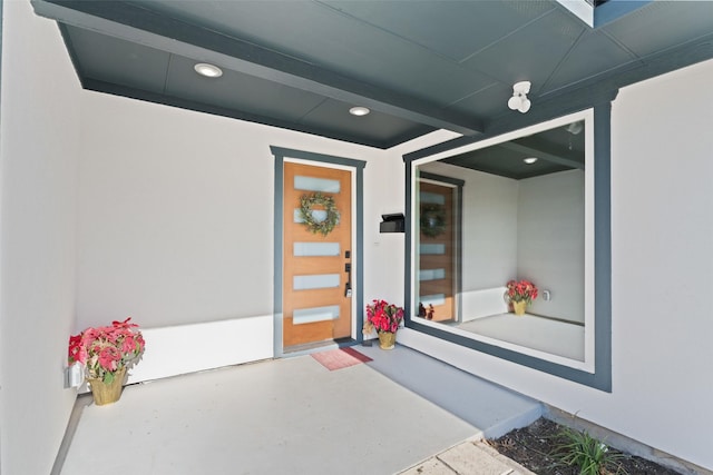 entrance to property featuring stucco siding