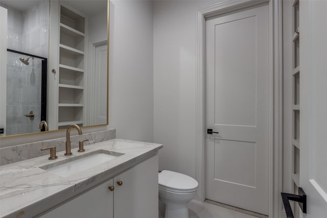 bathroom featuring walk in shower, vanity, and toilet