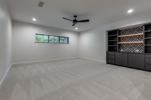 spare room featuring ceiling fan and light carpet