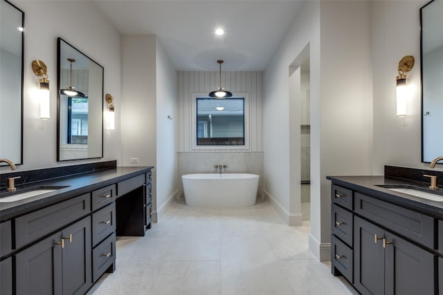 bathroom with vanity, a healthy amount of sunlight, and a bathing tub