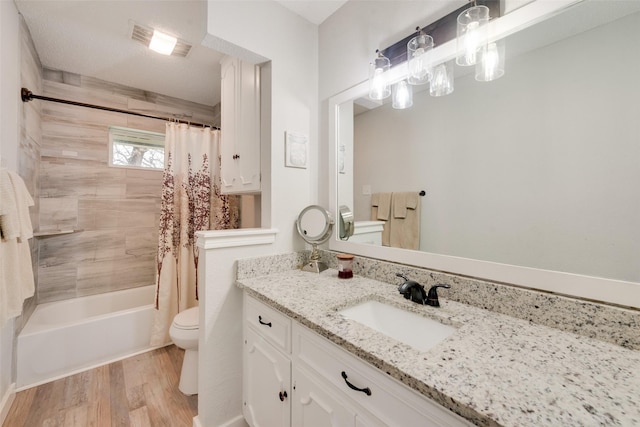 full bathroom featuring wood-type flooring, vanity, toilet, and shower / tub combo