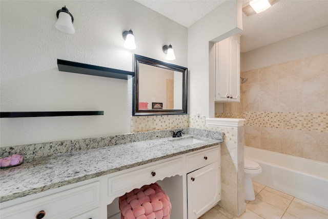 full bathroom featuring tile patterned floors, toilet, tile walls, a textured ceiling, and vanity