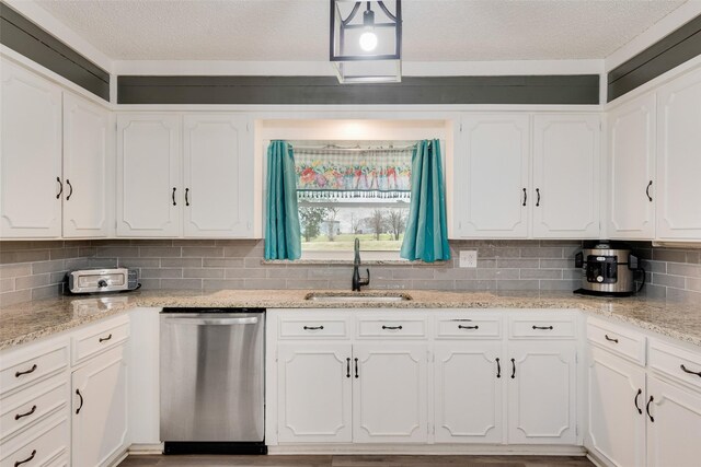 kitchen featuring white cabinets, a sink, and stainless steel dishwasher