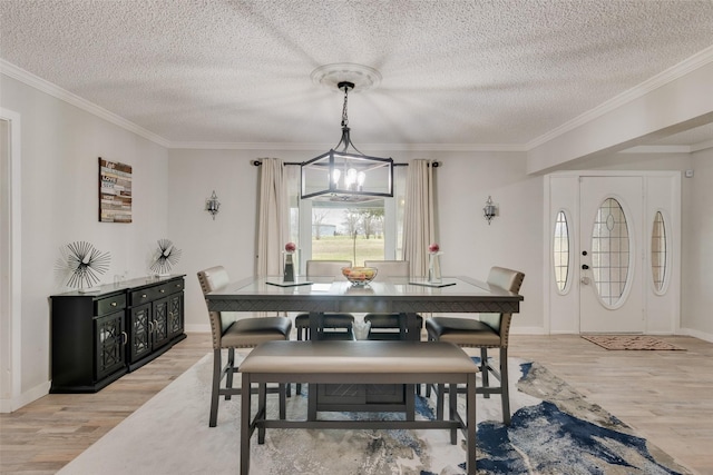 dining room with crown molding, a textured ceiling, and light hardwood / wood-style floors