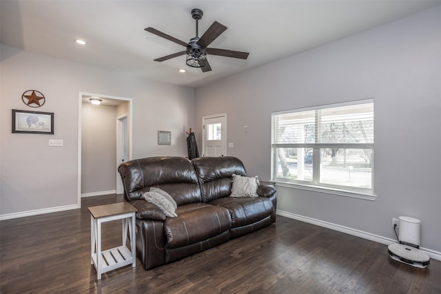 living room featuring ceiling fan and dark hardwood / wood-style floors