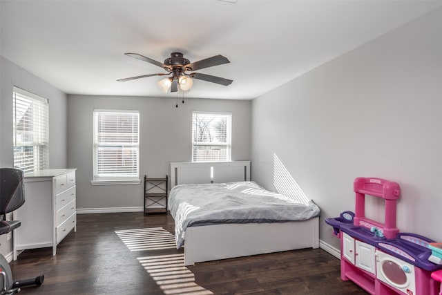 bedroom with ceiling fan, dark hardwood / wood-style floors, and multiple windows