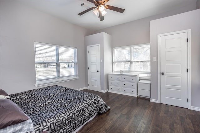 bedroom with dark hardwood / wood-style flooring and ceiling fan