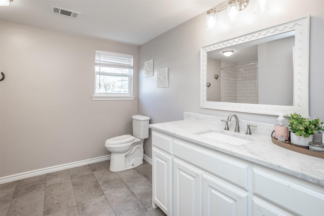 bathroom featuring walk in shower, vanity, and toilet