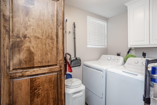 laundry room with independent washer and dryer and cabinets