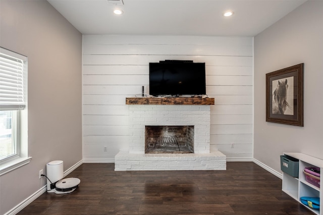 unfurnished living room with a fireplace and dark hardwood / wood-style floors