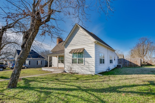 bungalow-style house featuring central AC and a front lawn