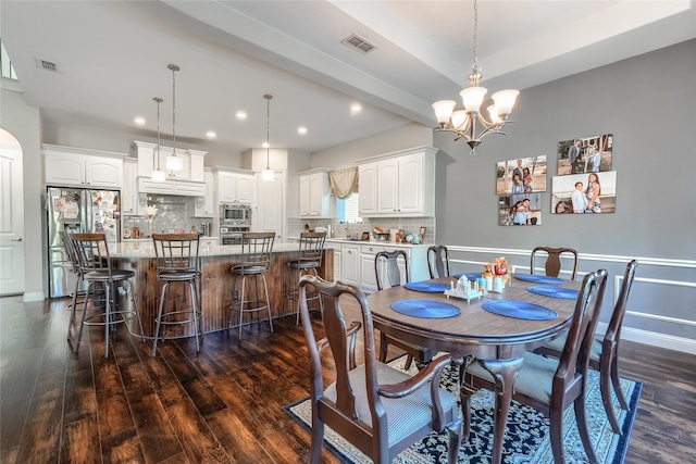 dining room with beamed ceiling, a chandelier, and dark hardwood / wood-style floors