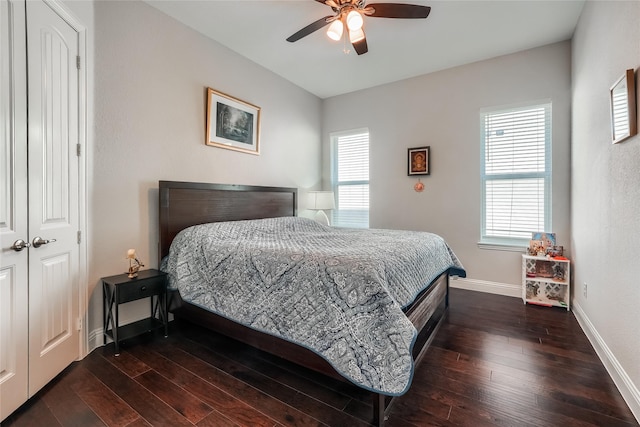 bedroom featuring ceiling fan, dark hardwood / wood-style flooring, and a closet