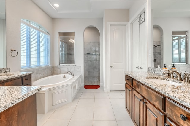 bathroom featuring vanity, tile patterned floors, and shower with separate bathtub