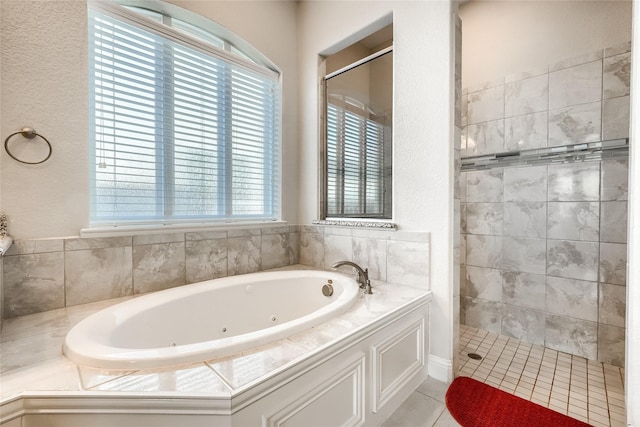 bathroom with a healthy amount of sunlight, plus walk in shower, and tile patterned floors