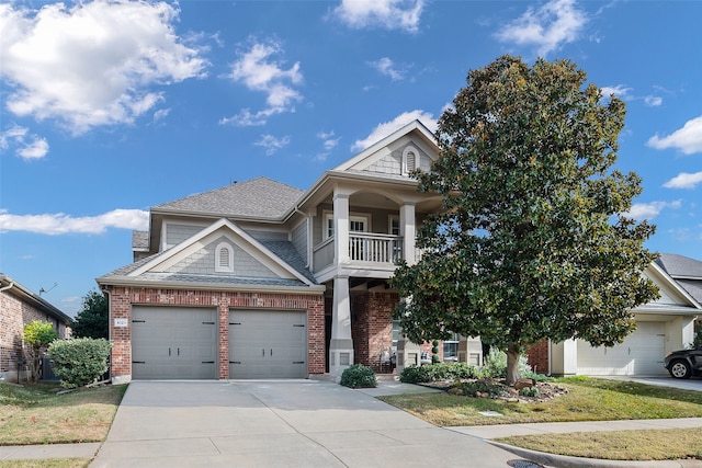 view of front of property featuring a balcony and a garage