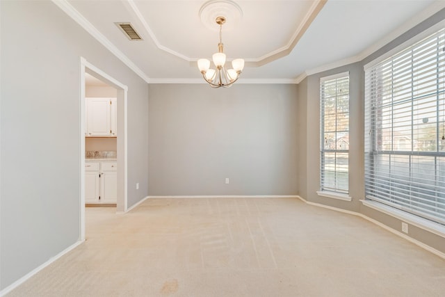 carpeted empty room featuring a raised ceiling, crown molding, and an inviting chandelier