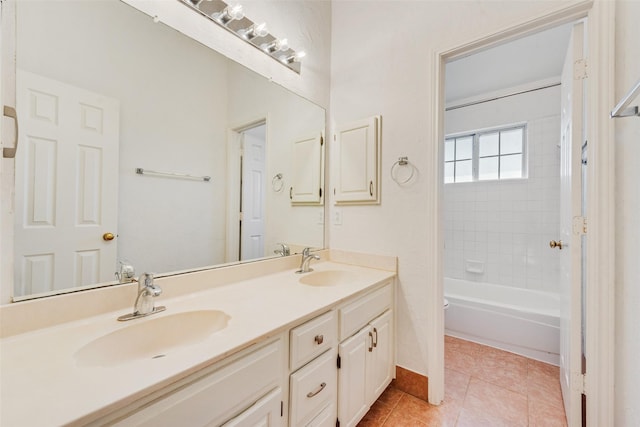 full bathroom with tiled shower / bath combo, vanity, tile patterned floors, and toilet