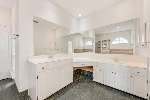 bathroom with vanity, an enclosed shower, and tile patterned floors