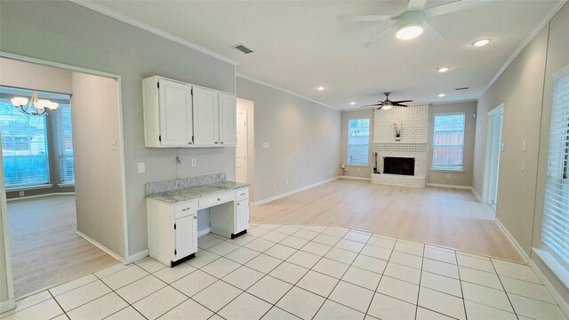 unfurnished living room with light carpet and ceiling fan with notable chandelier