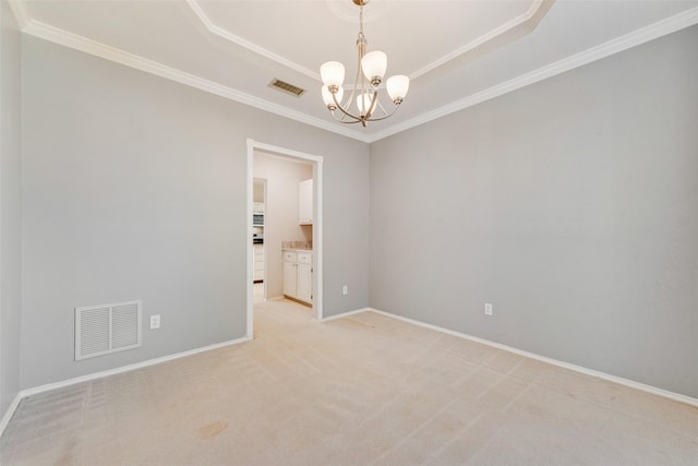 empty room featuring a notable chandelier, light colored carpet, and ornamental molding