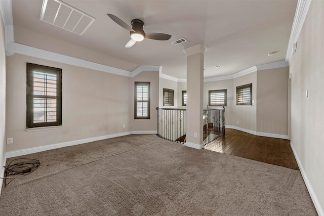 unfurnished room featuring ceiling fan, ornamental molding, carpet, and ornate columns