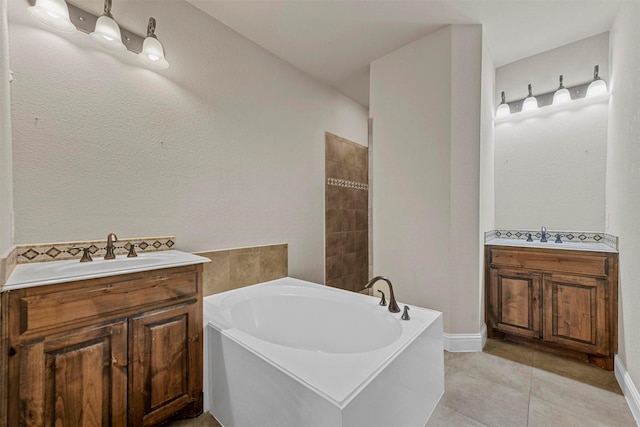 bathroom with vanity, tile patterned floors, and a bathing tub