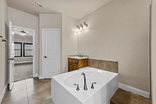 bathroom with tile patterned flooring, vanity, and a bathtub