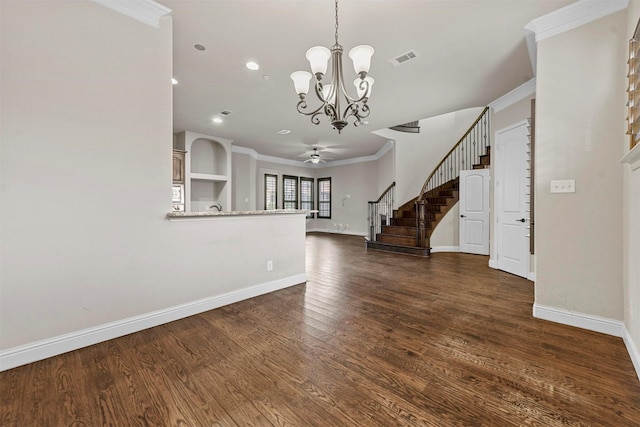 interior space featuring ornamental molding, ceiling fan with notable chandelier, and dark hardwood / wood-style flooring