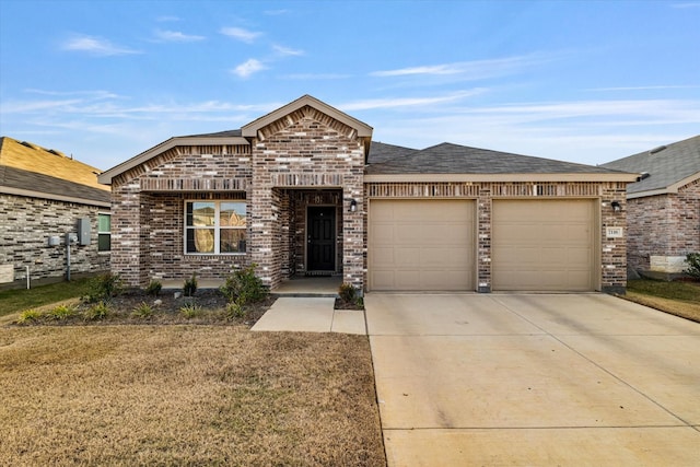 view of front of home with a garage and a front lawn