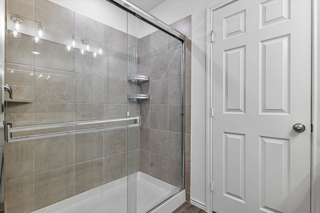 bathroom featuring a shower with shower door