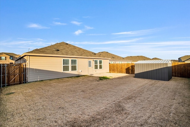 rear view of house featuring a shed