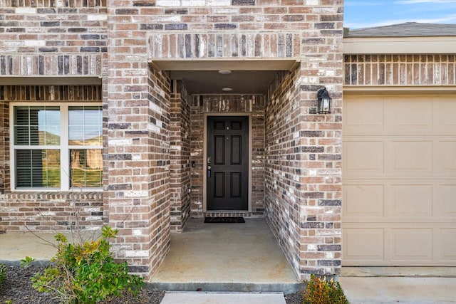 view of exterior entry featuring a garage