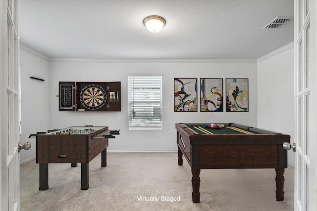 game room with light carpet, pool table, a textured ceiling, and ornamental molding