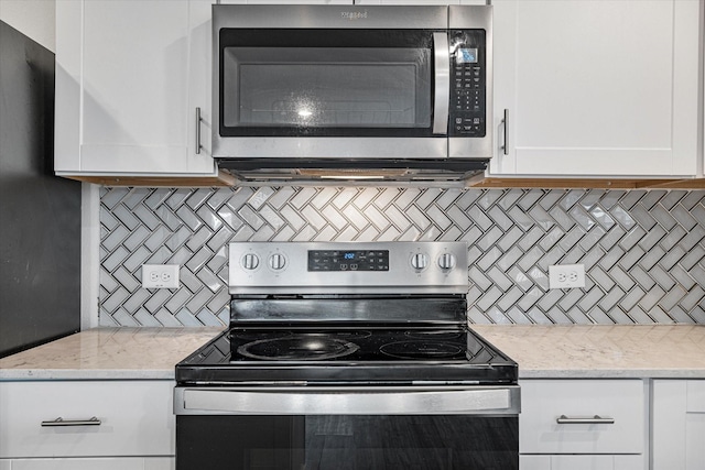 kitchen featuring white cabinets, light stone counters, appliances with stainless steel finishes, and tasteful backsplash