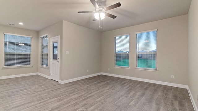 empty room featuring ceiling fan and light hardwood / wood-style flooring