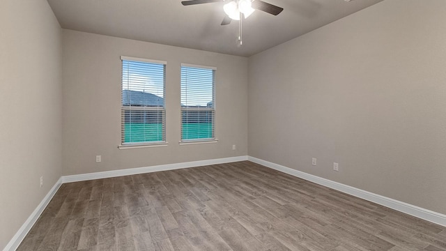 empty room featuring ceiling fan and light hardwood / wood-style flooring