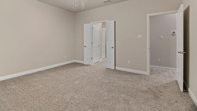 unfurnished bedroom featuring light carpet