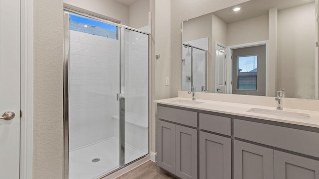 bathroom featuring vanity, hardwood / wood-style floors, and a shower with shower door