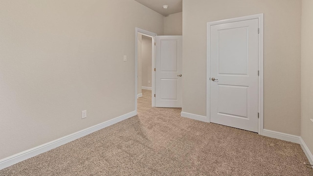 unfurnished bedroom featuring light carpet