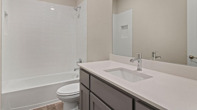 full bathroom featuring vanity, hardwood / wood-style floors, tiled shower / bath combo, and toilet